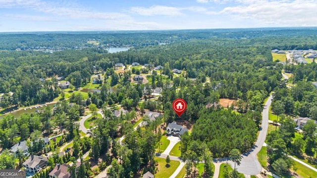 1131 Glen Eagle Dr, Greensboro, GA 30642 - aerial view of property and surrounding area with a heavily wooded area and nearby suburban area