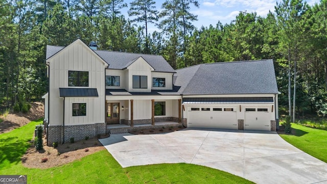 1131 Glen Eagle Dr, Greensboro, GA 30642 - modern farmhouse with board and batten siding, an attached garage, driveway, and a shingled roof