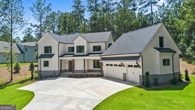1131 Glen Eagle Dr, Greensboro, GA 30642 - modern farmhouse featuring board and batten siding, concrete driveway, covered porch, and a standing seam roof