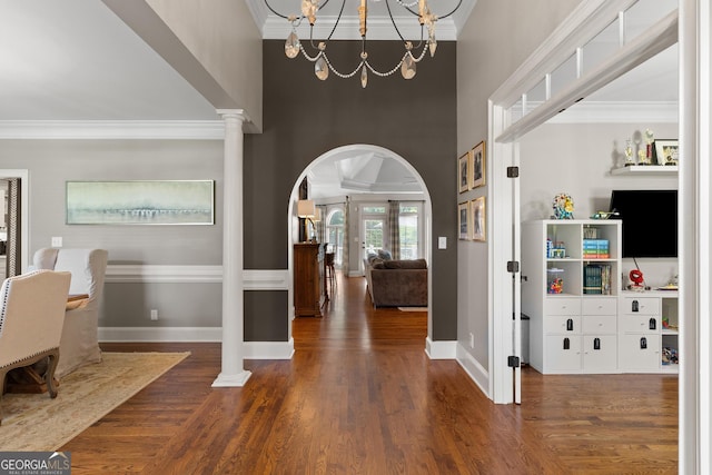 660 Milton Dr, Mcdonough, GA 30252 - foyer featuring arched walkways, crown molding, wood finished floors, a high ceiling, and a chandelier