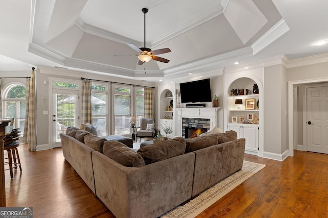 660 Milton Dr, Mcdonough, GA 30252 - living area featuring ceiling fan, crown molding, a fireplace, a raised ceiling, and wood finished floors