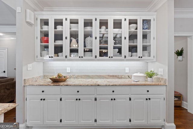 660 Milton Dr, Mcdonough, GA 30252 - bar featuring backsplash, ornamental molding, and dark wood-type flooring