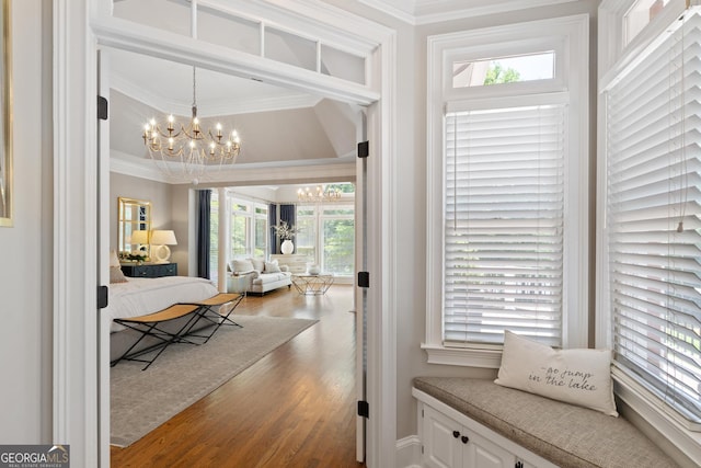660 Milton Dr, Mcdonough, GA 30252 - corridor featuring ornamental molding, a chandelier, and wood finished floors