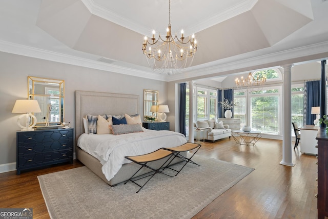 660 Milton Dr, Mcdonough, GA 30252 - bedroom featuring a chandelier, wood finished floors, ornamental molding, and a tray ceiling