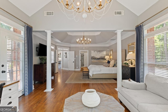 660 Milton Dr, Mcdonough, GA 30252 - bedroom with ornate columns, a chandelier, wood finished floors, ornamental molding, and high vaulted ceiling
