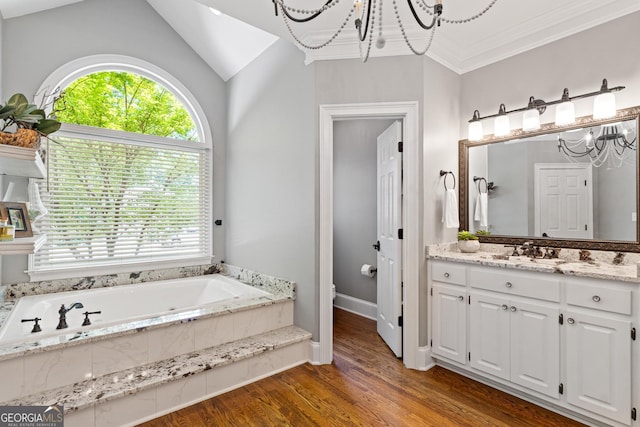 660 Milton Dr, Mcdonough, GA 30252 - full bath with a chandelier, vanity, a garden tub, wood finished floors, and lofted ceiling