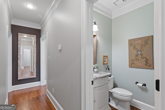 660 Milton Dr, Mcdonough, GA 30252 - half bathroom featuring vanity, ornamental molding, and wood finished floors