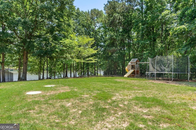 660 Milton Dr, Mcdonough, GA 30252 - view of yard featuring a trampoline and a playground