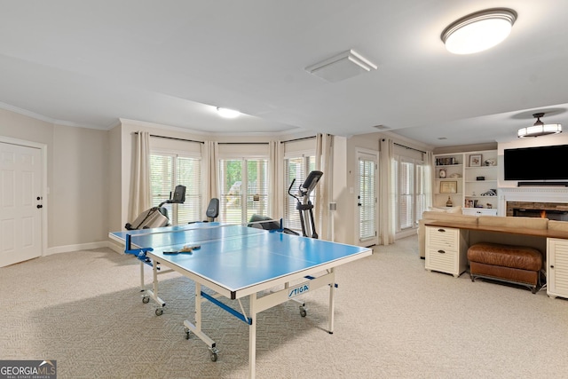 660 Milton Dr, Mcdonough, GA 30252 - game room with carpet flooring, crown molding, and a lit fireplace