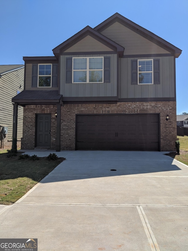 120 Magnaview Dr, Mcdonough, GA 30253 - view of front of house featuring brick siding, an attached garage, driveway, and board and batten siding