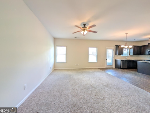 120 Magnaview Dr, Mcdonough, GA 30253 - unfurnished living room featuring ceiling fan, carpet, and a chandelier