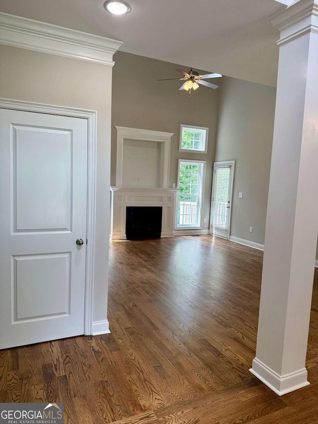 205 Huntington Shoals Dr, Athens, GA 30606 - unfurnished living room with a ceiling fan, dark wood-type flooring, a fireplace, a towering ceiling, and recessed lighting