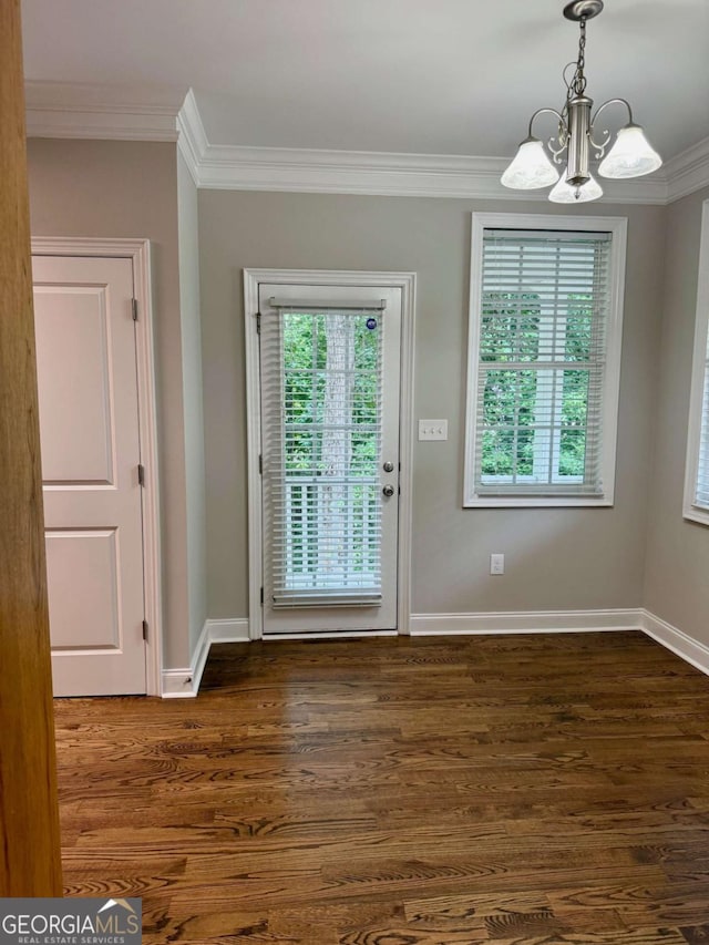 205 Huntington Shoals Dr, Athens, GA 30606 - unfurnished dining area featuring a chandelier, ornamental molding, and dark wood-style floors