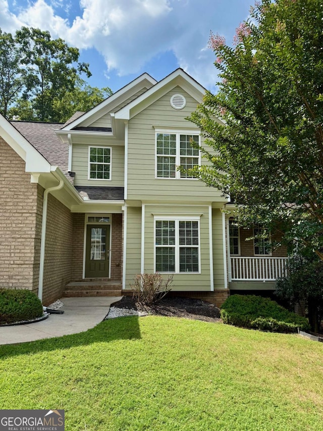 205 Huntington Shoals Dr, Athens, GA 30606 - view of front facade featuring a front yard, brick siding, covered porch, and roof with shingles