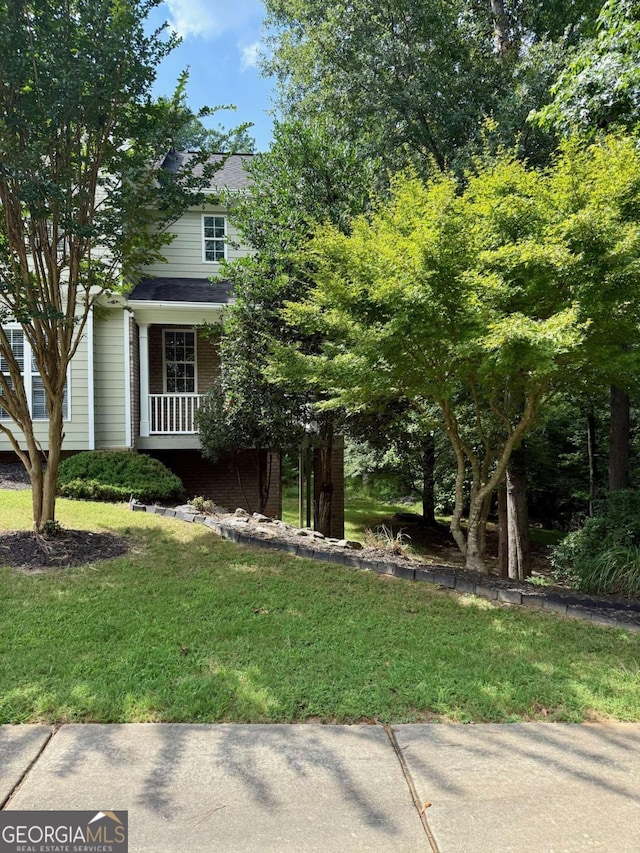205 Huntington Shoals Dr, Athens, GA 30606 - view of property hidden behind natural elements featuring a front lawn and brick siding