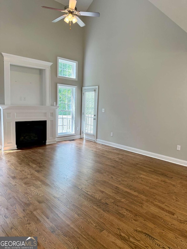 205 Huntington Shoals Dr, Athens, GA 30606 - unfurnished living room featuring high vaulted ceiling, wood finished floors, a ceiling fan, and a fireplace
