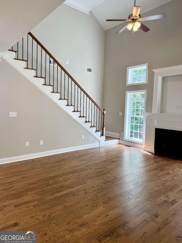 205 Huntington Shoals Dr, Athens, GA 30606 - unfurnished living room featuring stairway, wood finished floors, high vaulted ceiling, a ceiling fan, and a fireplace