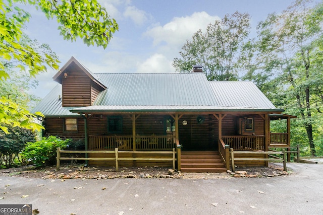 105 Ranch Mountain Ct, Dahlonega, GA 30533 - view of front of house with a porch, a metal roof, a chimney, and log veneer siding