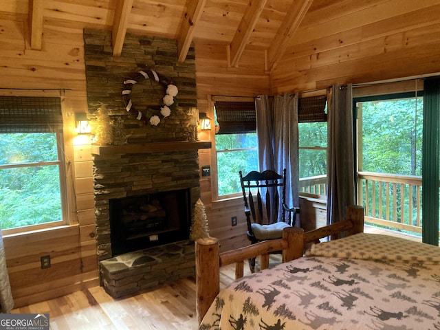 105 Ranch Mountain Ct, Dahlonega, GA 30533 - bedroom with wooden walls, wood finished floors, wood ceiling, multiple windows, and a fireplace