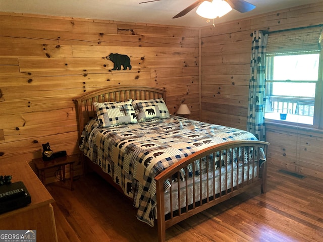105 Ranch Mountain Ct, Dahlonega, GA 30533 - bedroom featuring wood finished floors, wood walls, and a ceiling fan