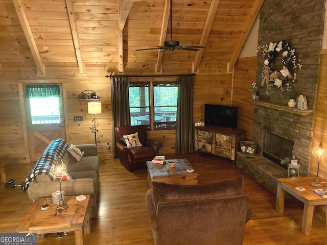 105 Ranch Mountain Ct, Dahlonega, GA 30533 - living area featuring wood finished floors, wooden ceiling, wood walls, ceiling fan, and a fireplace