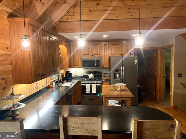 105 Ranch Mountain Ct, Dahlonega, GA 30533 - kitchen featuring appliances with stainless steel finishes, brown cabinetry, dark countertops, and hanging light fixtures