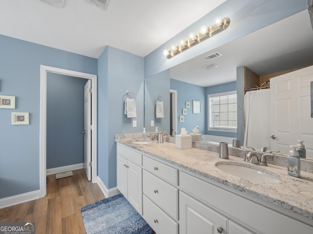1804 Maxey Ln, Winder, GA 30680 - bathroom with double vanity and wood finished floors