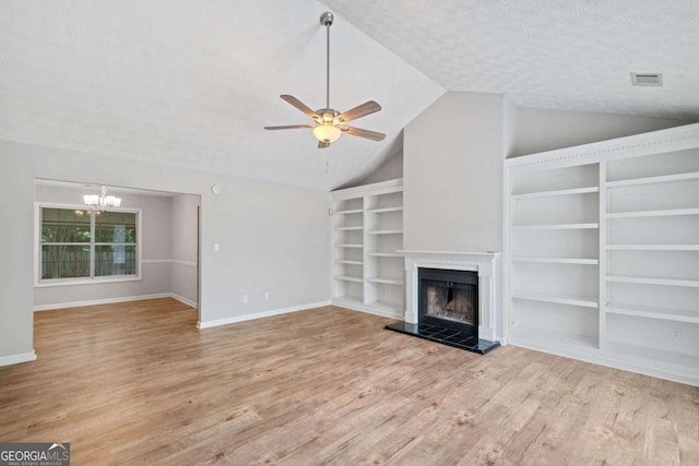 3997 Paloverde Dr NW, Kennesaw, GA 30144 - unfurnished living room with wood finished floors, a ceiling fan, a chandelier, lofted ceiling, and a fireplace with raised hearth