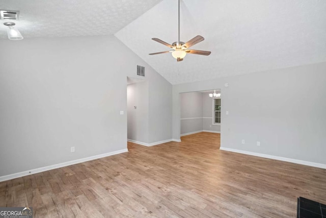 3997 Paloverde Dr NW, Kennesaw, GA 30144 - unfurnished living room featuring ceiling fan, a chandelier, vaulted ceiling, and wood finished floors