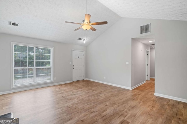 3997 Paloverde Dr NW, Kennesaw, GA 30144 - unfurnished living room featuring a ceiling fan, wood finished floors, a textured ceiling, and high vaulted ceiling