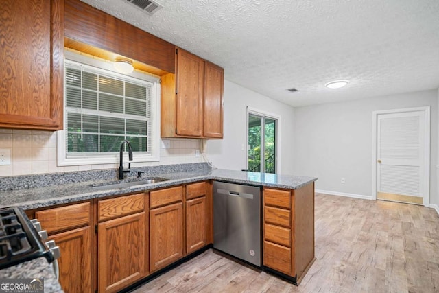 3997 Paloverde Dr NW, Kennesaw, GA 30144 - kitchen with dishwasher, light wood-style flooring, a peninsula, tasteful backsplash, and dark stone counters