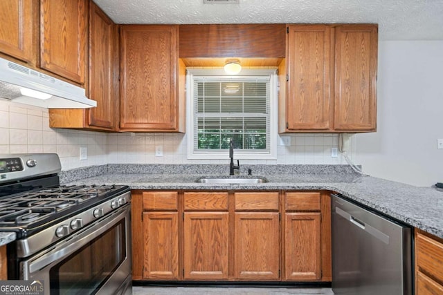 3997 Paloverde Dr NW, Kennesaw, GA 30144 - kitchen featuring stainless steel appliances, under cabinet range hood, light stone counters, and tasteful backsplash