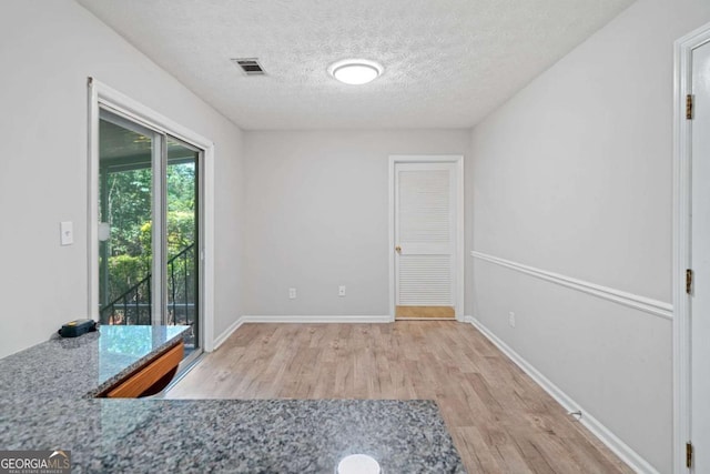 3997 Paloverde Dr NW, Kennesaw, GA 30144 - unfurnished dining area with wood finished floors and a textured ceiling