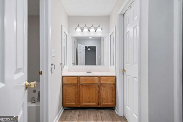 3997 Paloverde Dr NW, Kennesaw, GA 30144 - bathroom with vanity, wood finished floors, and a textured ceiling