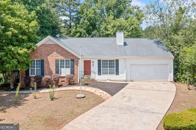 3997 Paloverde Dr NW, Kennesaw, GA 30144 - view of front of property with concrete driveway, an attached garage, a chimney, and brick siding