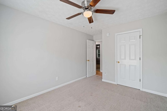 3997 Paloverde Dr NW, Kennesaw, GA 30144 - unfurnished bedroom featuring carpet floors, a textured ceiling, and ceiling fan