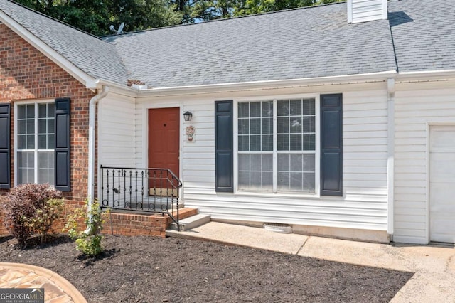 3997 Paloverde Dr NW, Kennesaw, GA 30144 - view of exterior entry featuring brick siding and a shingled roof