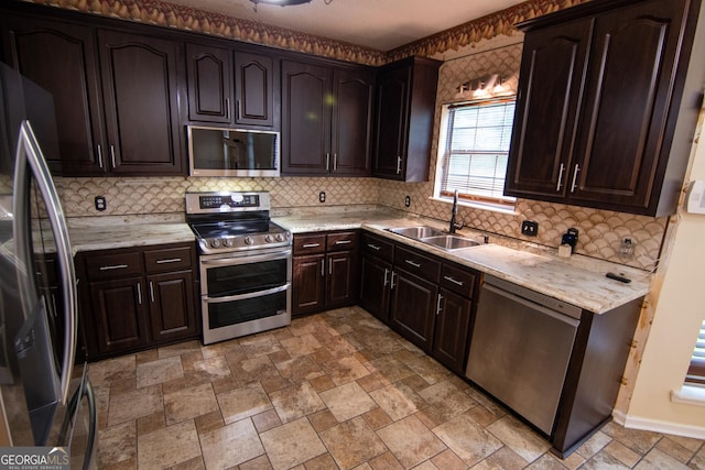 214 Hunters Chase, Byron, GA 31008 - kitchen featuring stainless steel appliances, backsplash, dark brown cabinetry, light stone finish flooring, and light stone countertops