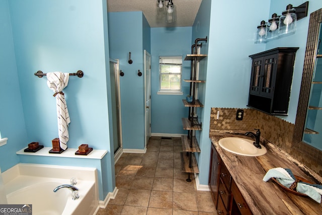 214 Hunters Chase, Byron, GA 31008 - bathroom with a shower stall, vanity, tile patterned flooring, a garden tub, and a textured ceiling