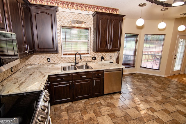 214 Hunters Chase, Byron, GA 31008 - kitchen with stainless steel appliances, backsplash, dark brown cabinets, decorative light fixtures, and stone finish floors