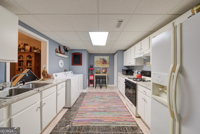 219 John Garner Rd, Dahlonega, GA 30533 - kitchen with white appliances, washer and clothes dryer, a drop ceiling, under cabinet range hood, and light countertops