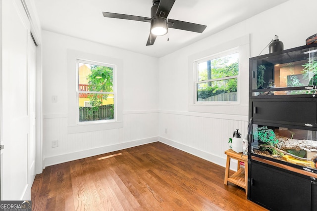 216 Leyden St, Decatur, GA 30030 - unfurnished bedroom with wainscoting, wood finished floors, and ceiling fan