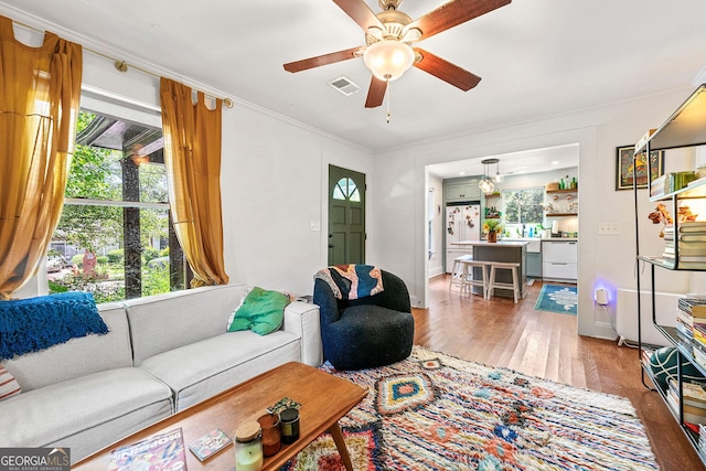 216 Leyden St, Decatur, GA 30030 - living room featuring light wood-style flooring, a ceiling fan, and crown molding