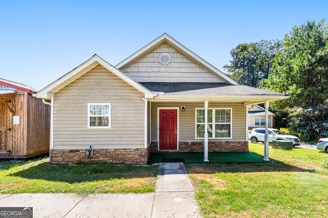 281 Northwinds Blvd Unit D-3, Carrollton, GA 30197 - view of front of property with a front yard, a porch, stone siding, and a shingled roof