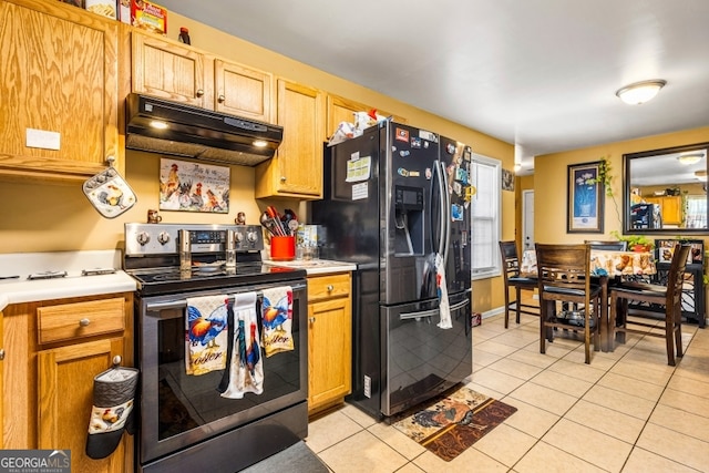 281 Northwinds Blvd Unit D-3, Carrollton, GA 30197 - kitchen featuring stainless steel electric range, under cabinet range hood, black fridge with ice dispenser, light tile patterned floors, and light countertops