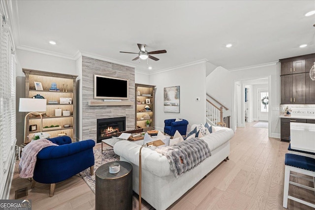 410 Anglin Walk, Alpharetta, GA 30009 - living room featuring stairs, ceiling fan, light wood finished floors, a tile fireplace, and recessed lighting