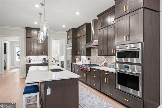 410 Anglin Walk, Alpharetta, GA 30009 - kitchen with wall chimney exhaust hood, appliances with stainless steel finishes, ornamental molding, light countertops, and light wood finished floors