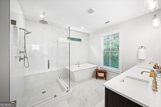 410 Anglin Walk, Alpharetta, GA 30009 - bathroom featuring a stall shower, a freestanding tub, double vanity, and marble finish flooring