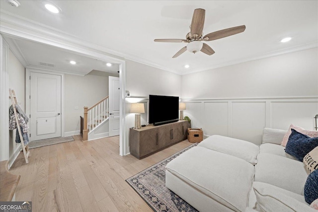 410 Anglin Walk, Alpharetta, GA 30009 - living room featuring stairway, ornamental molding, light wood-style floors, a ceiling fan, and a decorative wall