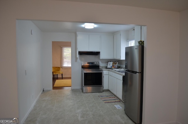 4447 Pharr Ave Unit 0, Macon, GA 31204 - kitchen with appliances with stainless steel finishes, under cabinet range hood, white cabinetry, and light countertops